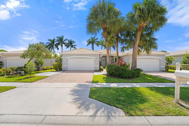 view of front of property with a garage and a front yard