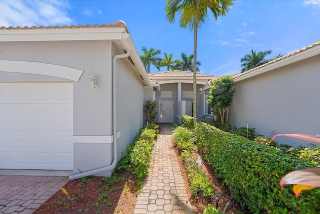 view of exterior entry with a garage