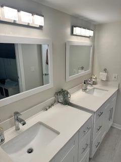 full bathroom featuring shower / bath combination with glass door, vanity, and toilet