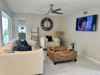 living room featuring ceiling fan and light tile patterned flooring