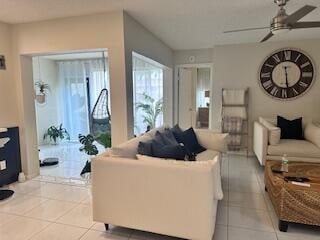 tiled living room featuring ceiling fan