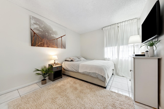 tiled bedroom with a textured ceiling