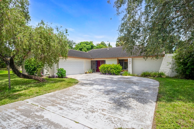 ranch-style house with a garage and a front lawn