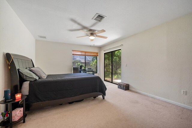 bedroom with access to outside, light colored carpet, and ceiling fan