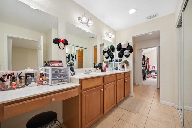 bathroom with tile patterned floors and vanity