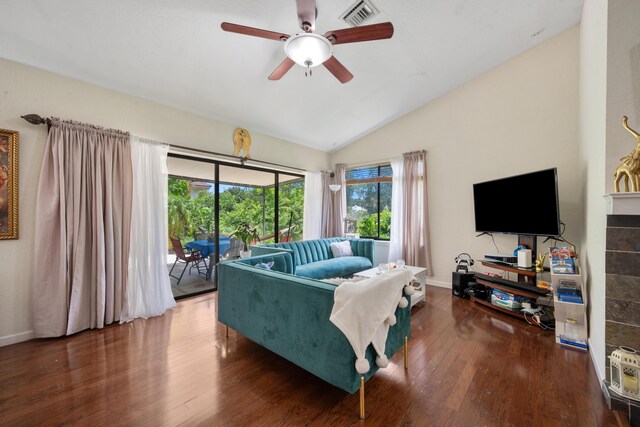 living room with wood-type flooring, lofted ceiling, and ceiling fan