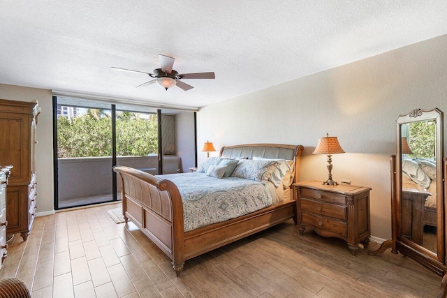 bedroom with hardwood / wood-style floors, a textured ceiling, and ceiling fan