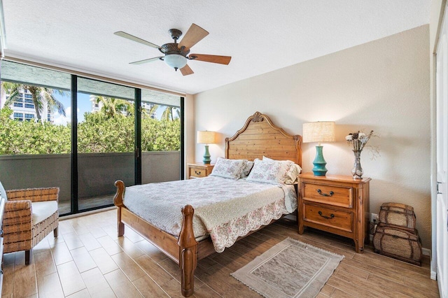 bedroom featuring floor to ceiling windows, access to exterior, and ceiling fan