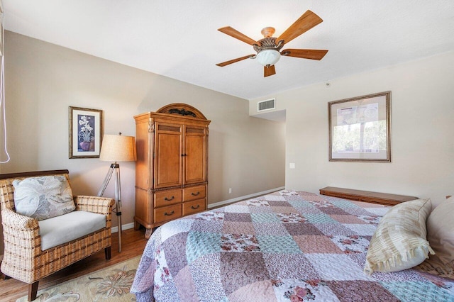 bedroom with ceiling fan and light hardwood / wood-style flooring