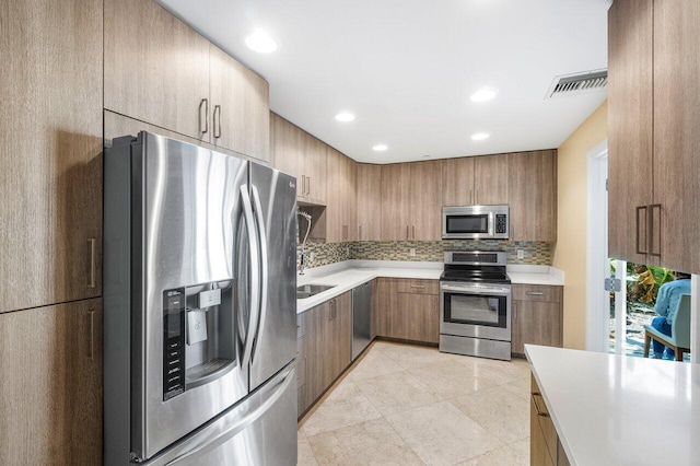 kitchen with backsplash and appliances with stainless steel finishes