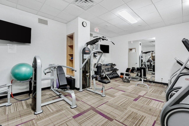 gym featuring carpet flooring and a drop ceiling