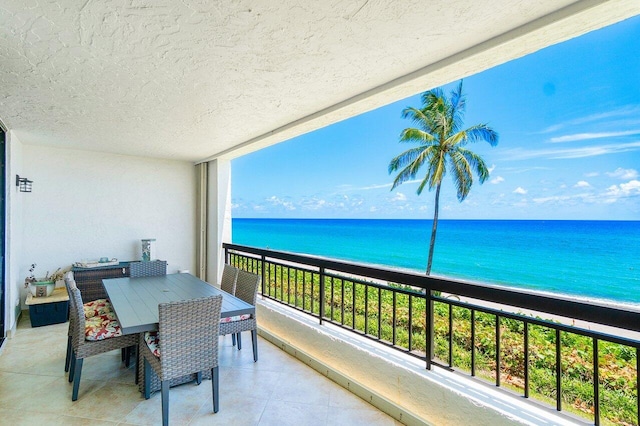 balcony featuring a water view and a view of the beach