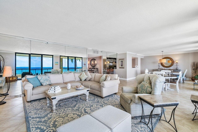 living room featuring crown molding, a wall of windows, a textured ceiling, and a water view