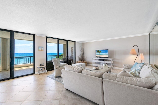 tiled living room featuring crown molding, a water view, floor to ceiling windows, and a textured ceiling