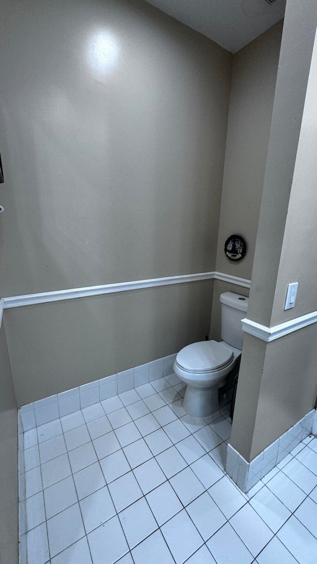 bathroom with toilet and tile patterned floors