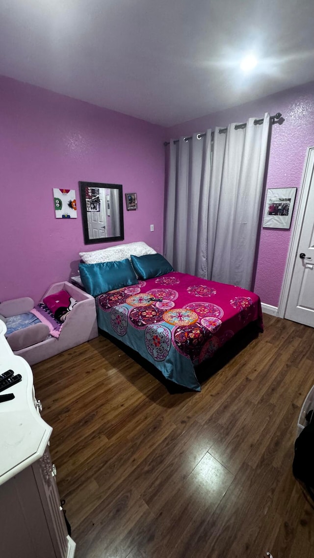 bedroom with wood-type flooring