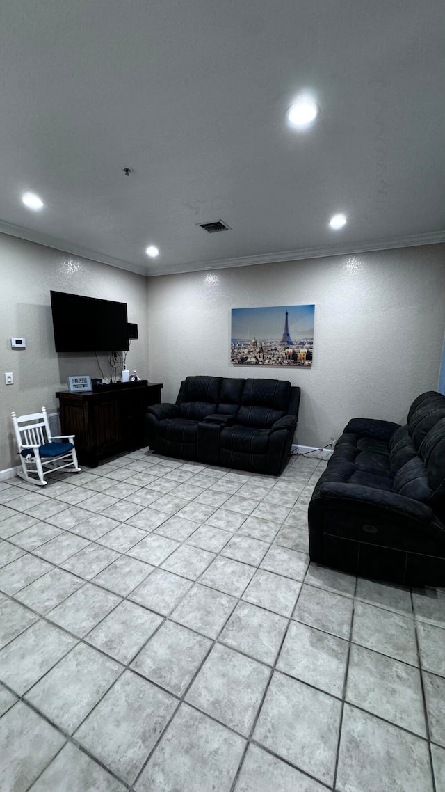 living room with ornamental molding and light tile patterned floors