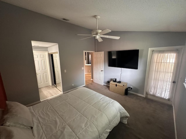 carpeted bedroom with lofted ceiling, a textured ceiling, and ceiling fan