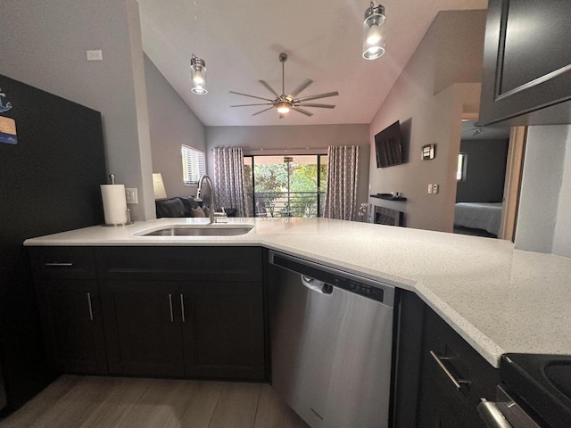 kitchen with lofted ceiling, dishwasher, sink, and light wood-type flooring