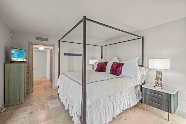 bedroom featuring light tile patterned flooring