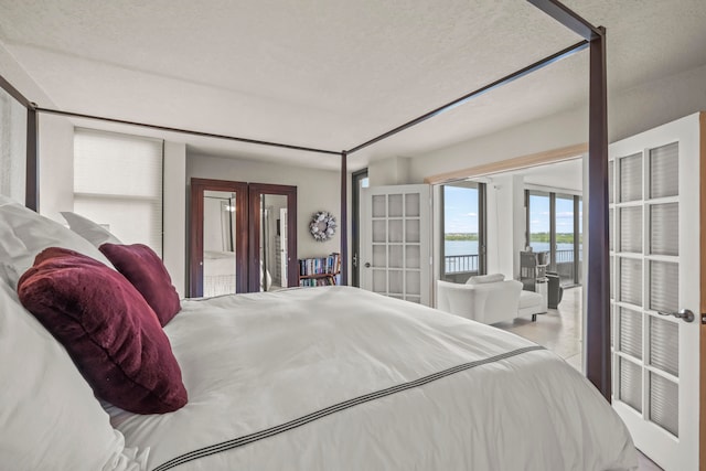 bedroom with french doors and a textured ceiling