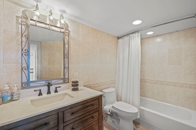 full bathroom featuring toilet, vanity, shower / tub combo, and tile walls