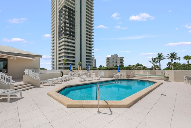 view of swimming pool featuring a patio area