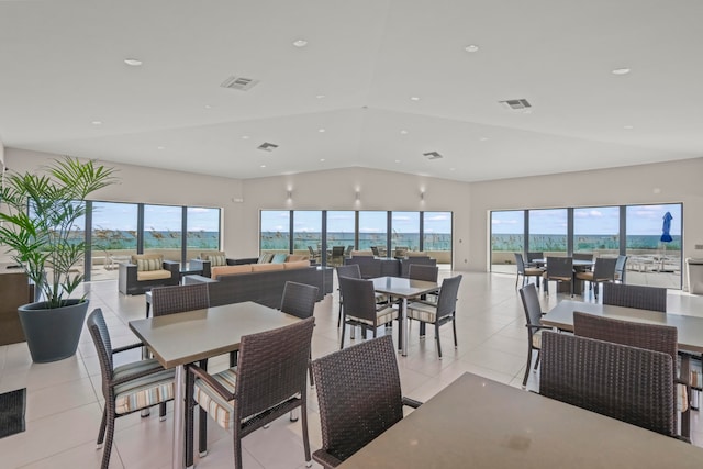 dining room featuring light tile patterned flooring and vaulted ceiling