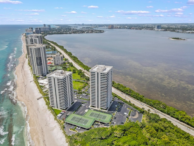 bird's eye view featuring a water view and a beach view