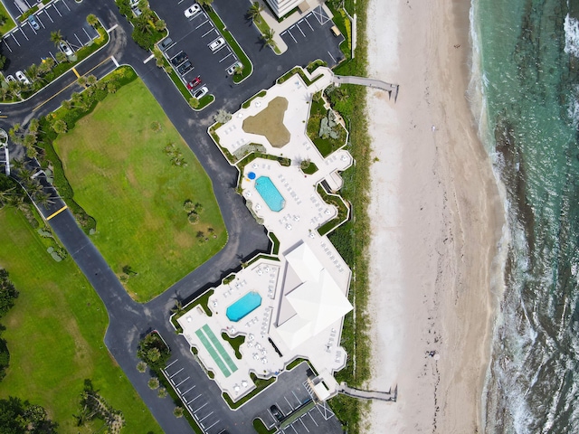 aerial view with a water view and a beach view