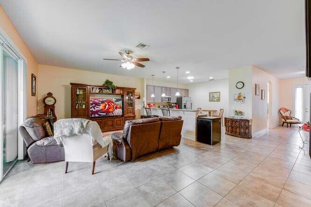 living area featuring recessed lighting, light tile patterned flooring, visible vents, and a ceiling fan