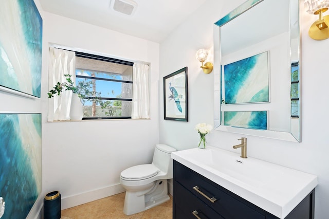 bathroom with tile patterned floors, vanity, and toilet