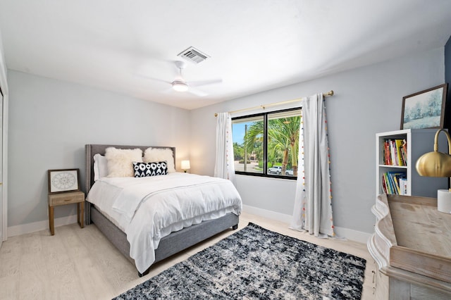 bedroom with ceiling fan and light hardwood / wood-style floors