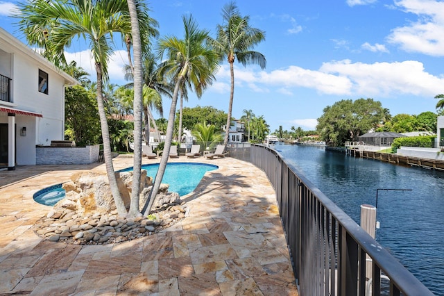 view of swimming pool featuring a water view and a patio area