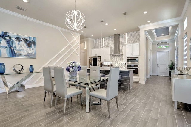 dining space featuring ornamental molding and a chandelier