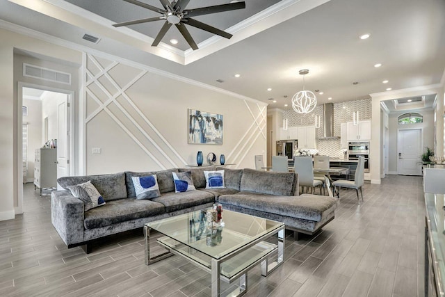 living room with crown molding and ceiling fan