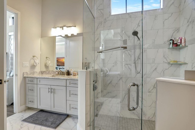 bathroom with a shower with door and vanity