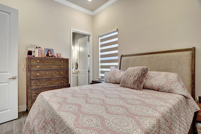 bedroom with crown molding, ensuite bathroom, and light wood-type flooring