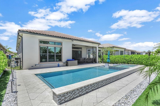 back of house with a pool with hot tub, a patio area, and ceiling fan