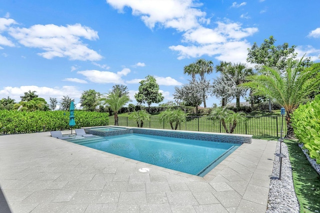 view of pool with a yard, a patio, and an in ground hot tub