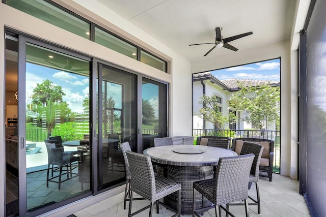 sunroom with ceiling fan and plenty of natural light