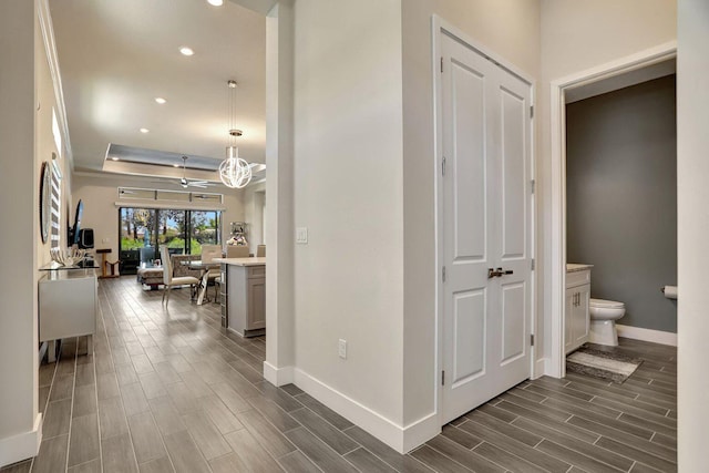 hall with a tray ceiling