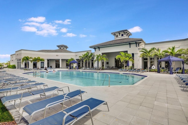 view of swimming pool with a patio and a gazebo