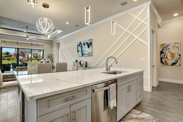 kitchen with dishwasher, sink, hanging light fixtures, ornamental molding, and a kitchen island with sink