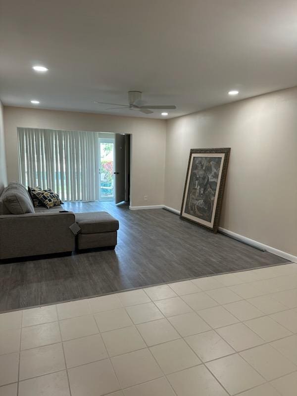 living room with ceiling fan and hardwood / wood-style flooring