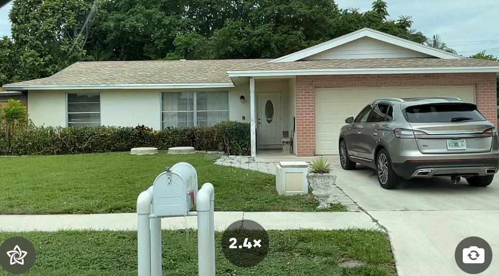 ranch-style house featuring a garage and a front yard