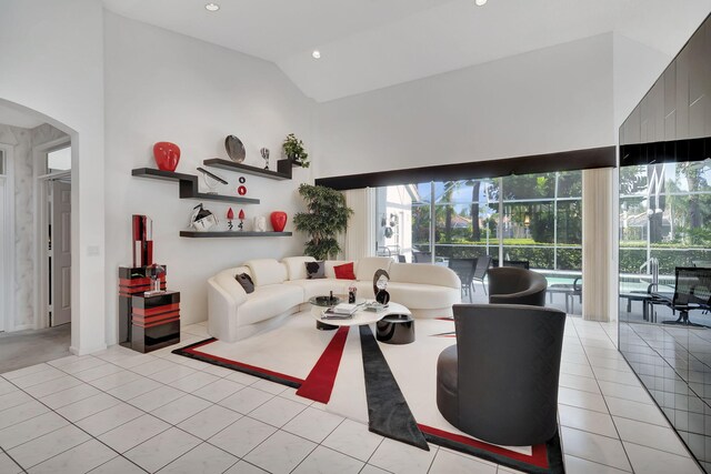 tiled living room with high vaulted ceiling