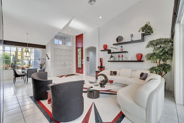 living room featuring a high ceiling and light tile patterned floors