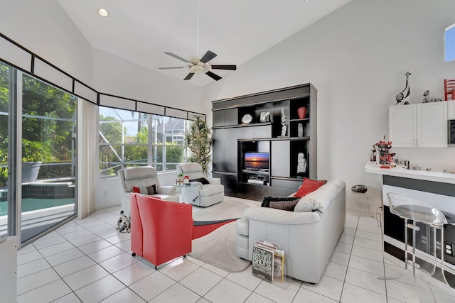 living room with high vaulted ceiling, light tile patterned floors, and ceiling fan