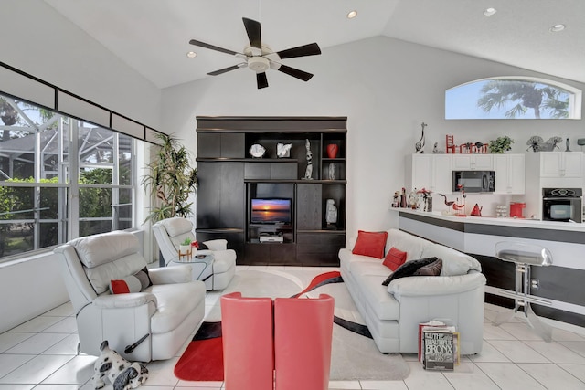 living room featuring ceiling fan, lofted ceiling, and light tile patterned floors